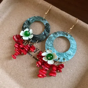 Close-up of New Chinese style resin drop earrings with white flowers and red beaded tassels