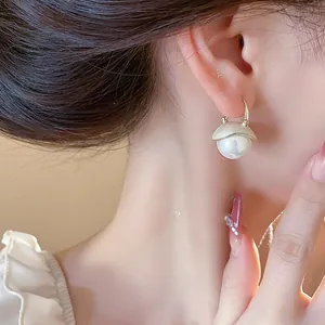 Elegant French style dripping oil round pearl ear buckle earrings shown on model