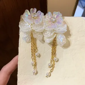 Elegant white floral tassel earrings with gold chains and hanging pearls for women