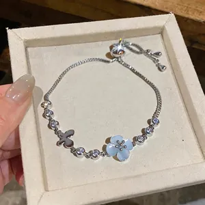 Exquisite silver bracelet featuring cat eye flower and zircon butterfly charms.