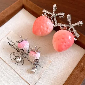 Elegant pink strawberry stud earrings featuring sparkling zircons and delicate bow design