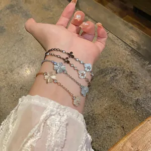 Close-up of elegant flower and butterfly bracelets with zircon and cat's eye stones