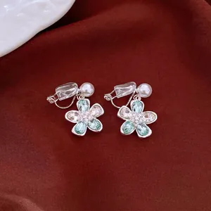 Elegant teal and clear crystal flower clip-on earrings with delicate pearl accents