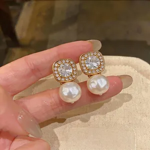 Elegant gold plated pearl stud earrings with shimmering zircon frame for women