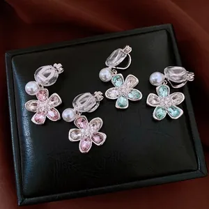 Exquisite sparkling crystal flower pearl clip-on earrings set on a premium black box