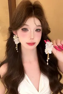 Elegant French resort style white floral tassel earrings with delicate gold fringe