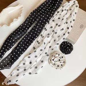 Detailed view of retro polka dot chiffon scarf and matching fabric flower accessories