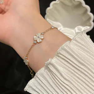 Close-up of elegant zircon cat's eye flower bracelet on woman's wrist