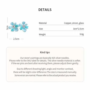 Close-up detail showing specifications for light blue flower earrings in copper and glass