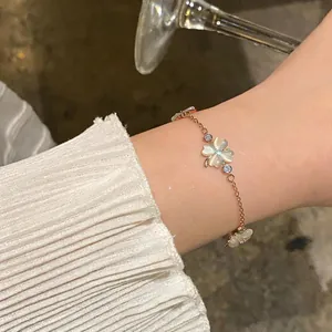 Close-up view of an elegant rose gold bracelet with zircon and cat's eye stone flowers