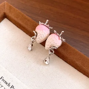 Close-up detail of sweet strawberry stud earrings with pink gradient and sparkling zircon drop