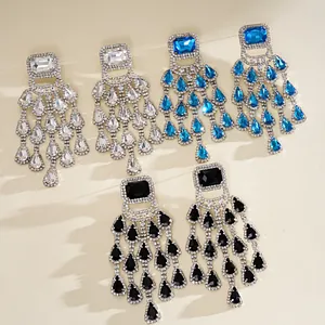 Detailed macro shot of glamorous chandelier earrings featuring tiered teardrop rhinestones