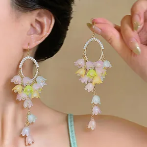 Detailed view of elegant long tassel earrings with colorful pastel flower charms