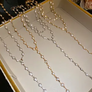 Close-up of double-layer necklaces featuring round acrylic glass beads in gold and silver.