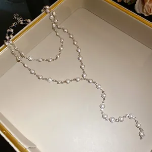 Close-up of double-layer necklace with elegant white glass beads and silver chain