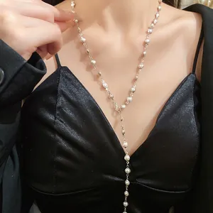 Detailed close-up of an elegant silver acrylic beaded drop necklace on a model's neck
