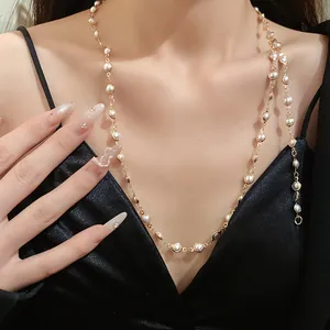 Detailed view of an elegant acrylic pearl double-layer necklace worn by a female model