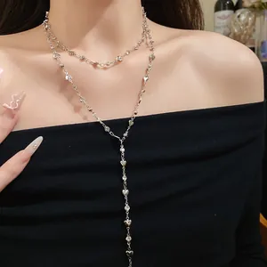 Close-up of double-layer silver necklace with heart beads and elegant Y-shape design