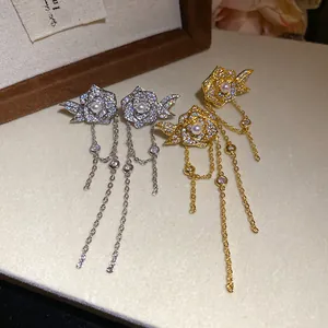 Detailed macro view of elegant rose tassel earrings with pearls and pave-set zircons