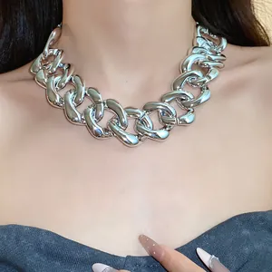 Close-up of chunky silver curb chain necklace on model