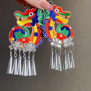 Traditional Chinese style knitted dragon clip-on earrings with silver metallic tassel pendants
