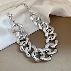 Close-up of vintage silver chunky chain necklace on elegant white satin background