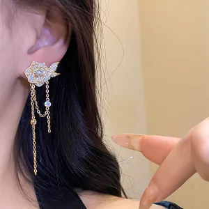 Close-up detail of an elegant 18K gold plated flower tassel earring with sparkling zircons