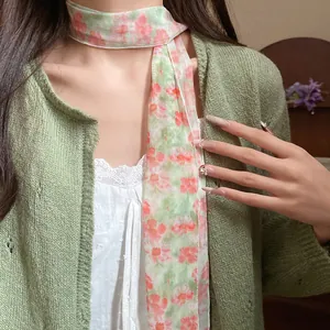 Close-up detail of a pastoral floral mesh scarf necklace worn as an elegant jewelry piece