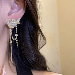 Close-up of 18K gold plated flower tassel earrings with zircons and pearl