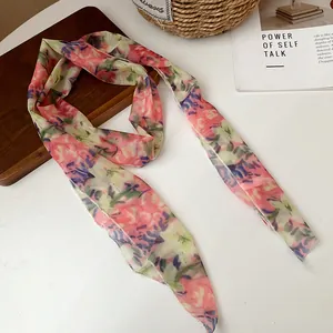 Detailed close-up of pastoral style floral mesh scarf necklace with pink petal pattern