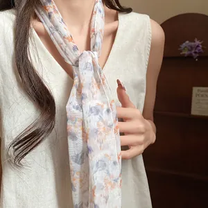 Detailed shot of an elegant pastoral floral mesh scarf worn as a delicate necklace