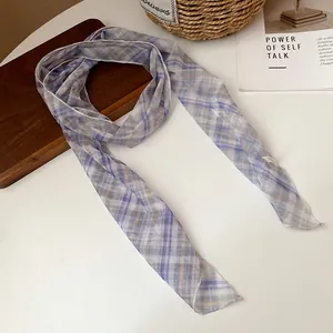 Detail view of pastoral purple plaid mesh scarf with sheer texture and neat stitching.