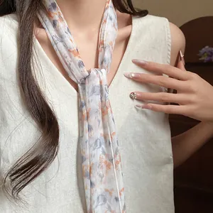 Detail view of floral mesh scarf necklace worn by a model in an elegant pastoral style