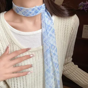 Elegant blue plaid mesh scarf necklace styled with a crochet sweater for a pastoral look.