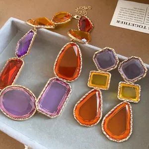 Gros plan d'un ensemble de bijoux en résine vintage avec pierres géométriques en monture dorée
