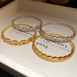 Macro detail of 18K gold plated zircon honeycomb and chain link bracelets