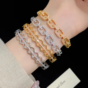 Detailed shot of 18K gold and silver plated zircon G-link and geometric bracelets