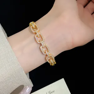 Close-up of elegant gold-plated bracelet featuring square links pave-set with sparkling zircons