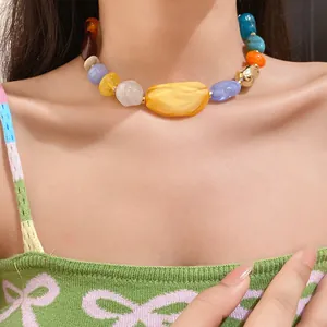 Detailed view of bohemian style necklace featuring colorful irregular acrylic beads on a model