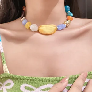 Detailed close-up of a bohemian acrylic irregular chunky bead choker necklace on a model