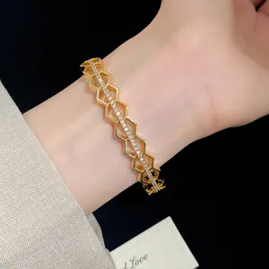 Detailed macro view of 18K gold plated honeycomb bangle with sparkling zircon inlays