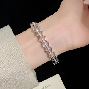 Exquisite detail of a silver-plated hexagonal hollow bangle with sparkling zircons.