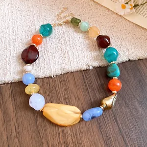 Close-up detail of colorful irregular acrylic beads on a Bohemian style necklace chain