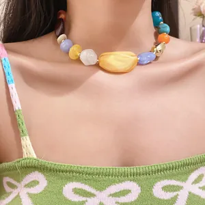 Detail view of colorful bohemian acrylic irregular beaded necklace on a model