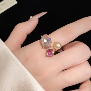 Macro detail of a vintage open ring with iridescent crystals and a golden pearl