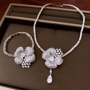 Detailed view of a luxury flower jewelry set with a sparkling zircon teardrop pendant.