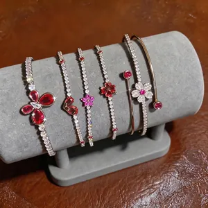 French style zircon bracelets with butterfly and floral charms on display stand