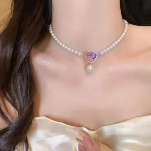 Close-up of elegant French vintage pearl choker with a brilliant pink heart zircon pendant