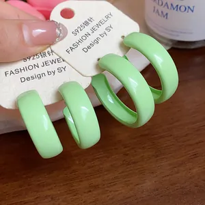 Close-up detail of light green enamel hoop earrings featuring S925 silver needles