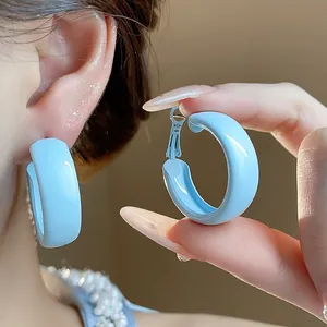 Detailed macro view of light blue spray-painted fashion hoop earrings for women